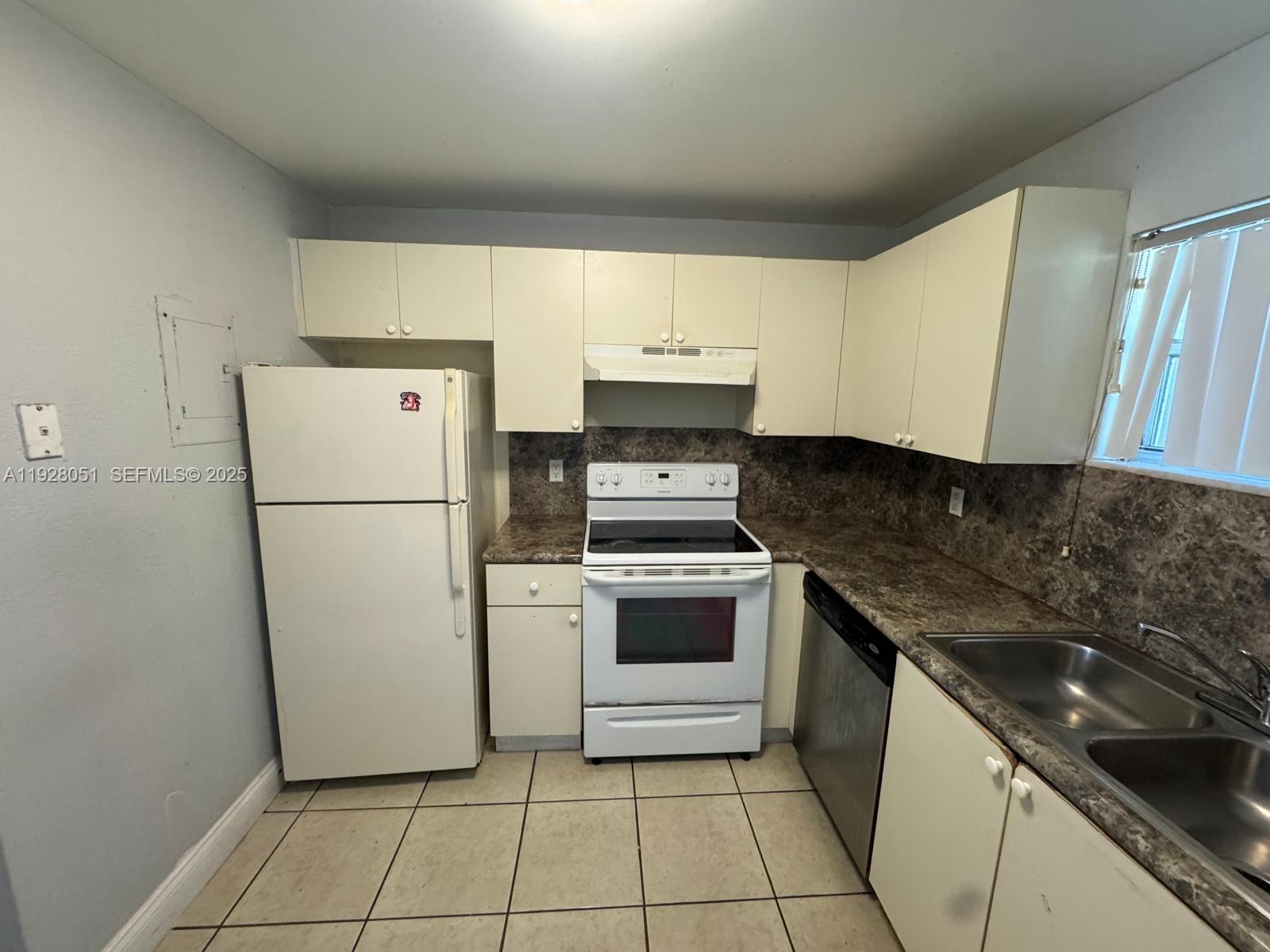 a kitchen with a stove a refrigerator and a sink