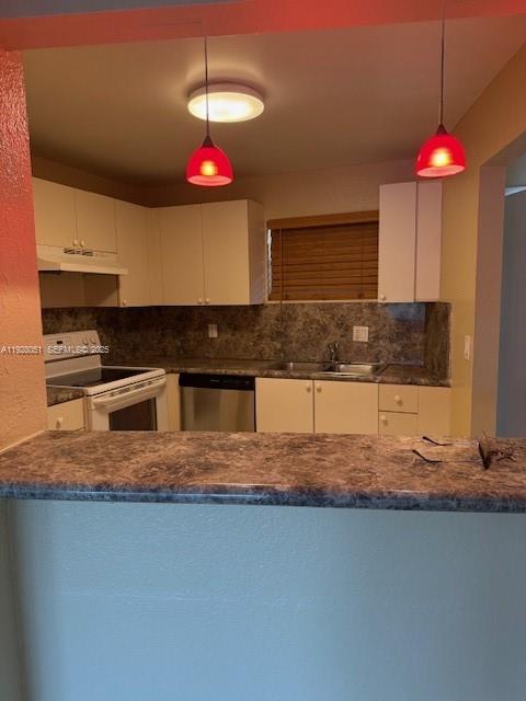 a kitchen that has a lot of cabinets and appliances