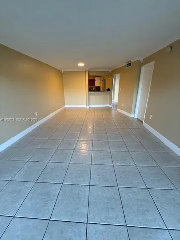a view of a livingroom with an empty space and a floor to ceiling window