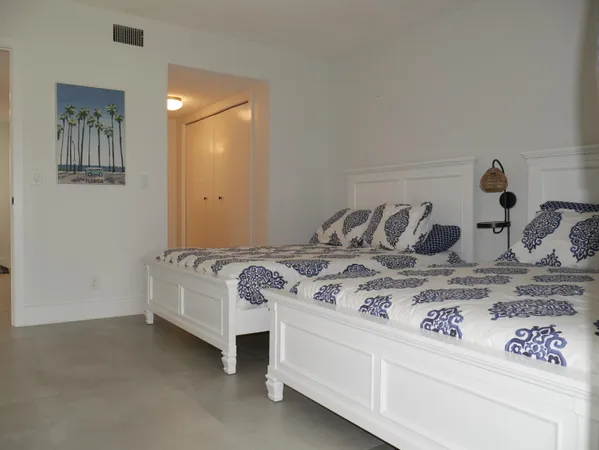 a bed sitting in a bedroom and dresser