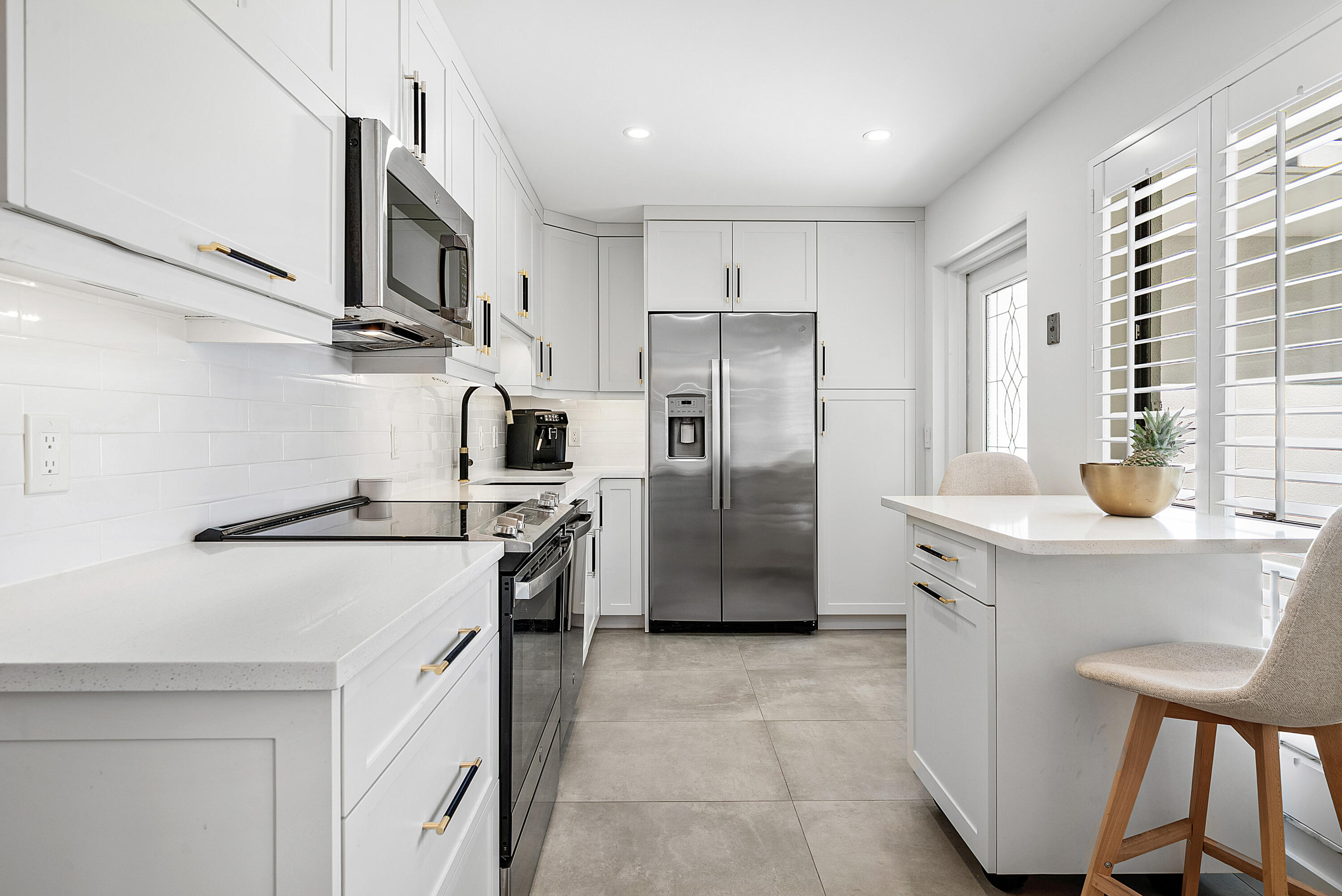4116 North Quail Ridge Drive, Unit A Boynton Beach, FL 33436 - Photo 18 of 41 a kitchen with stainless steel appliances a refrigerator sink and stove