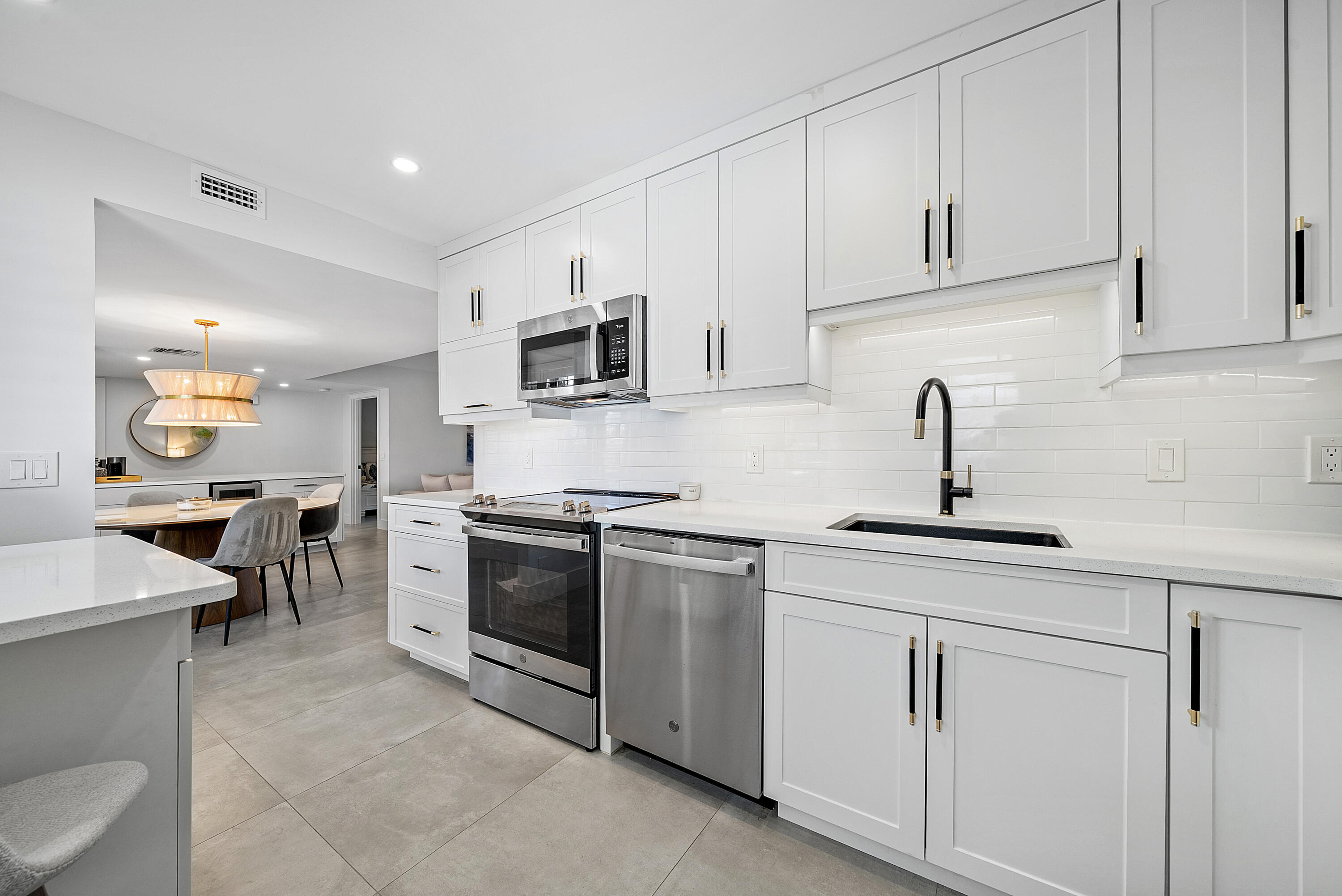 4116 North Quail Ridge Drive, Unit A Boynton Beach, FL 33436 - Photo 19 of 41 a kitchen with appliances a sink and cabinets
