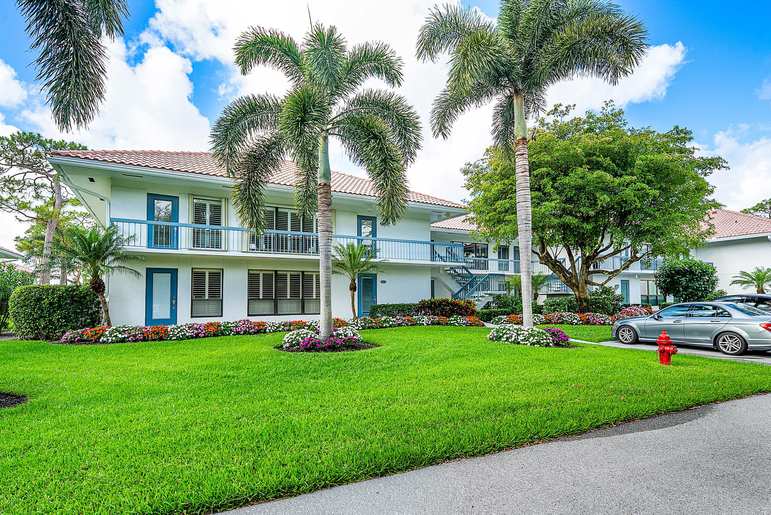 4116 North Quail Ridge Drive, Unit A Boynton Beach, FL 33436 - Photo 6 of 41 a front view of a house with a garden and trees