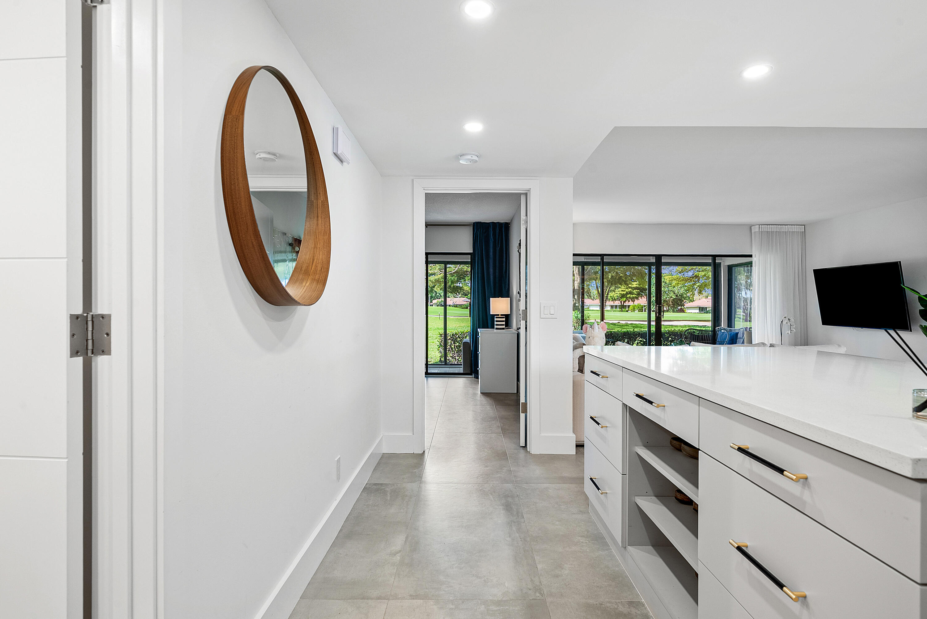 4116 North Quail Ridge Drive, Unit A Boynton Beach, FL 33436 - Photo 10 of 41 a room with a table and a mirror