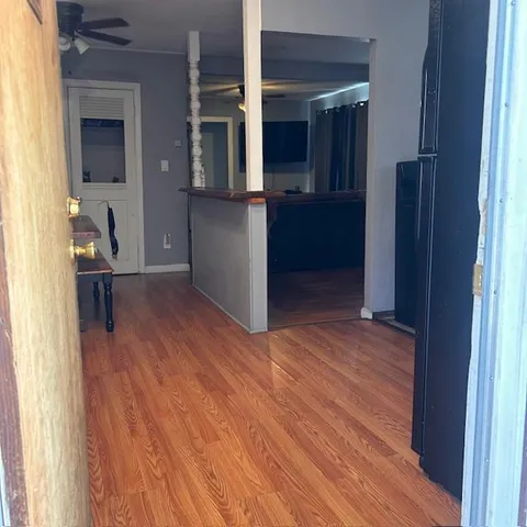 a view of a workspace with furniture and wooden floor