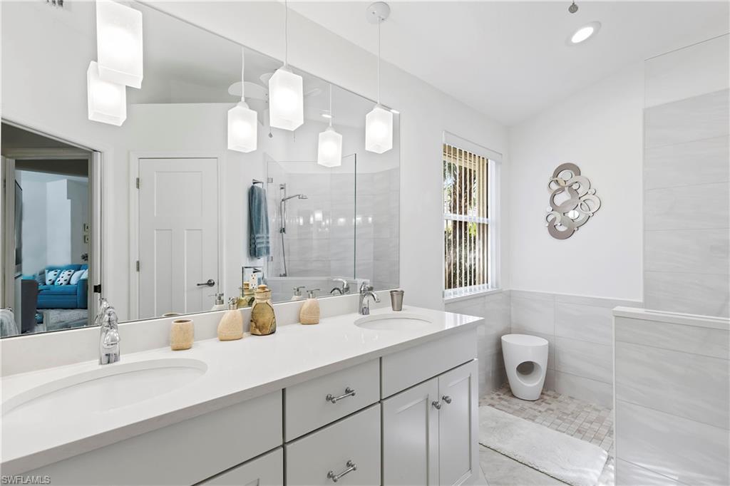 1269 Silverstrand Drive Naples, FL 34110 - Photo 7 of 43 Updated primary bath with quartz and remodeled shower.