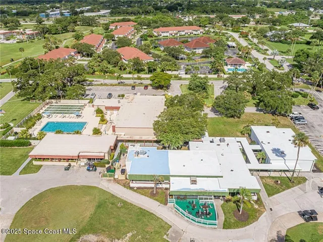 an aerial view of residential houses with outdoor space and parking
