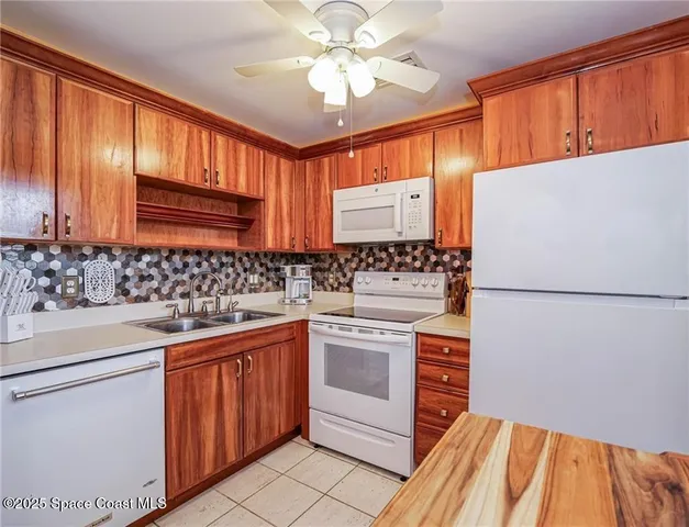 a kitchen with stainless steel appliances a stove a sink and a refrigerator