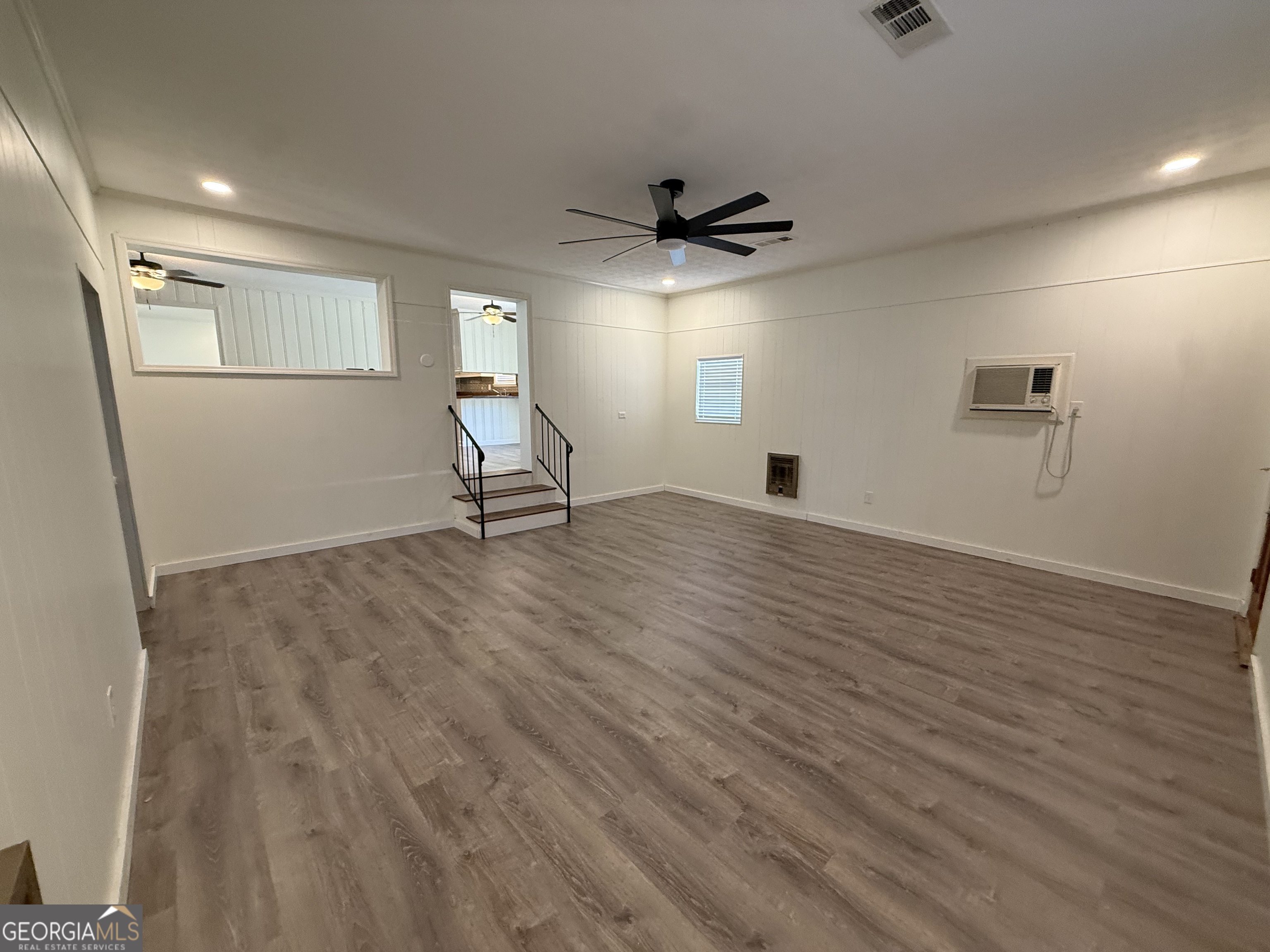 108 Plum Street Dublin, GA 31021 - Photo 32 of 33 a an empty room with wooden floor and a ceiling fan