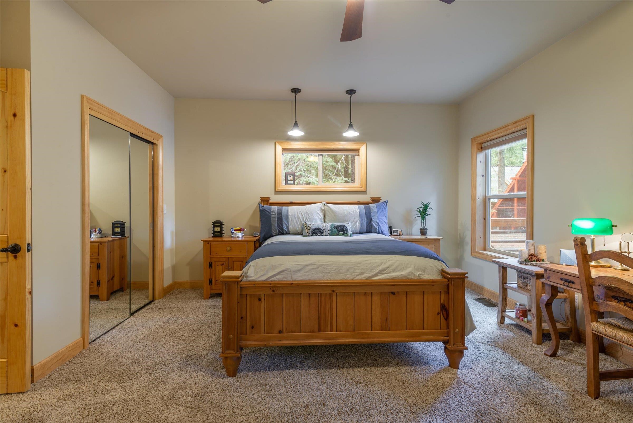 10308 Washoe Road Truckee, CA 96161 - Photo 13 of 21 a bedroom with a bed and a chandelier