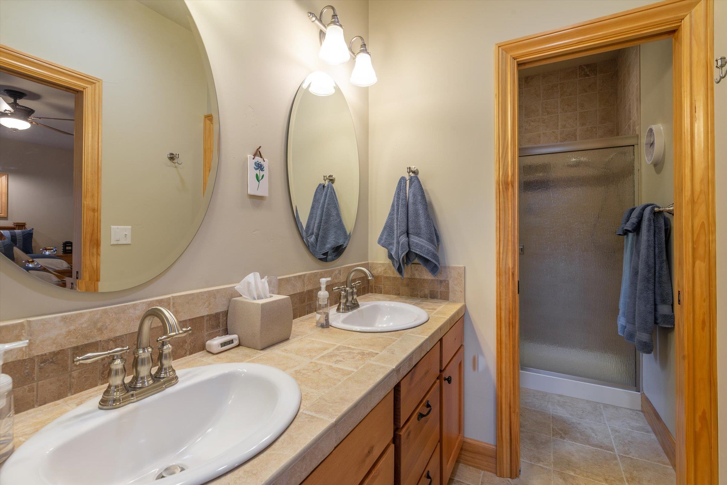 10308 Washoe Road Truckee, CA 96161 - Photo 14 of 21 a bathroom with double vanity sinks and a mirror