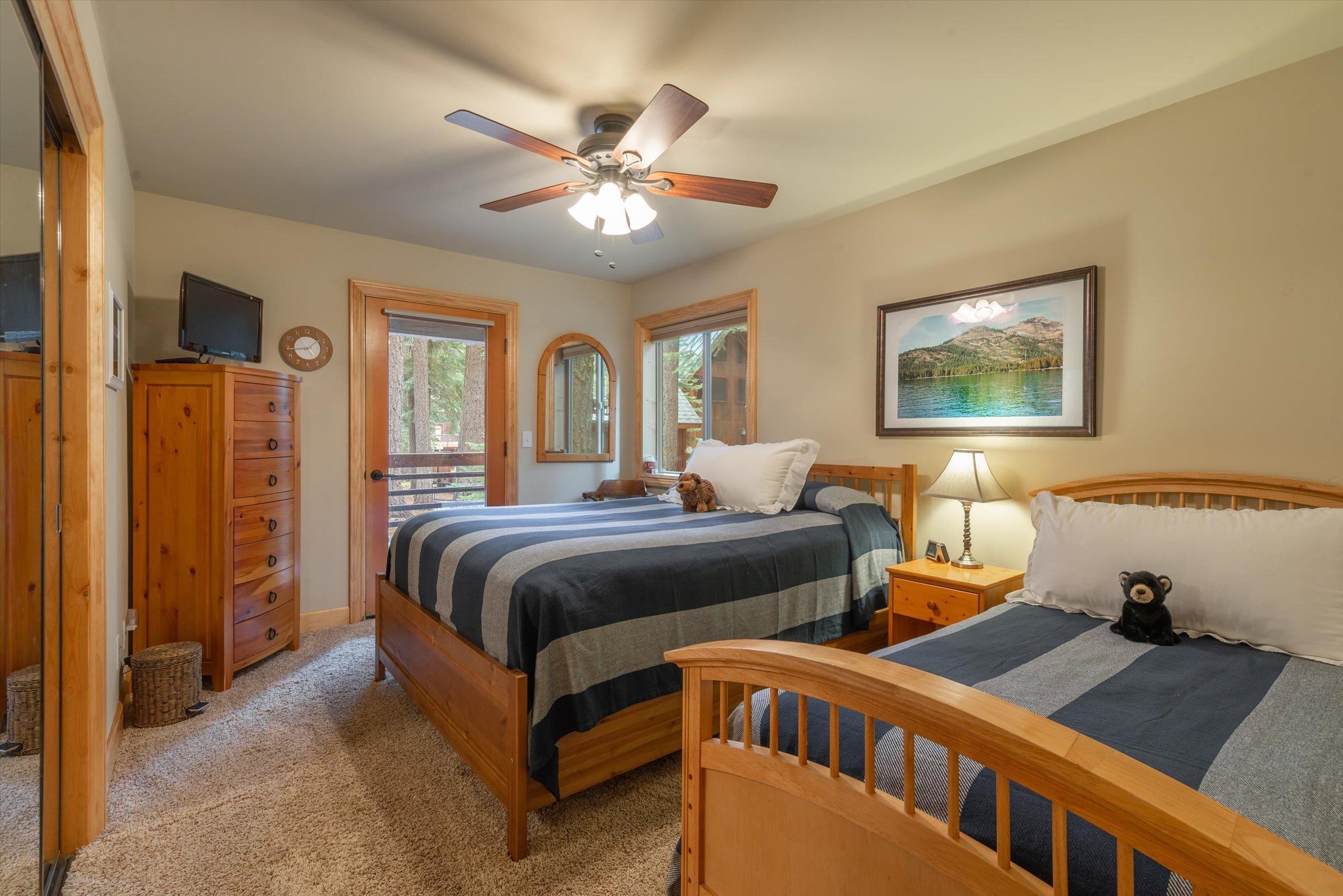 10308 Washoe Road Truckee, CA 96161 - Photo 17 of 21 a bedroom with furniture and a chandelier