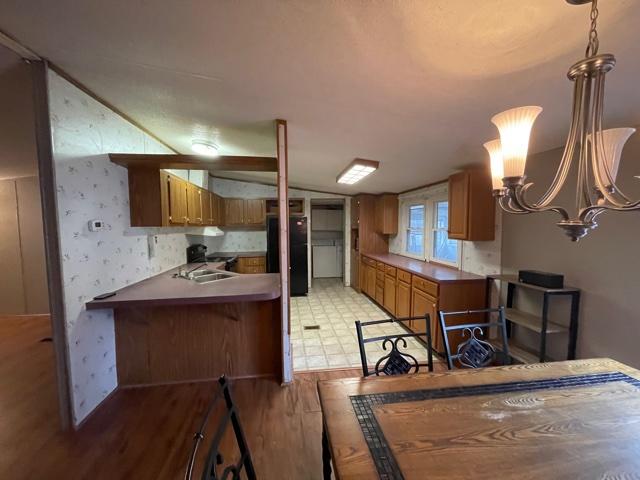 2830 Sha-Al Road Roanoke, VA 24014 - Photo 6 of 17 a room with view of kitchen island stainless steel appliances wooden floor and chair