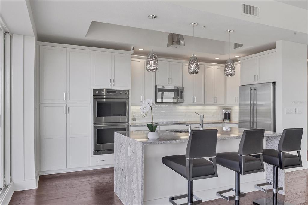10530 Boardwalk Loop, Unit 601 Bradenton, FL 34202 - Photo 13 of 60 a view of kitchen with cabinets stainless steel appliances and wooden floor