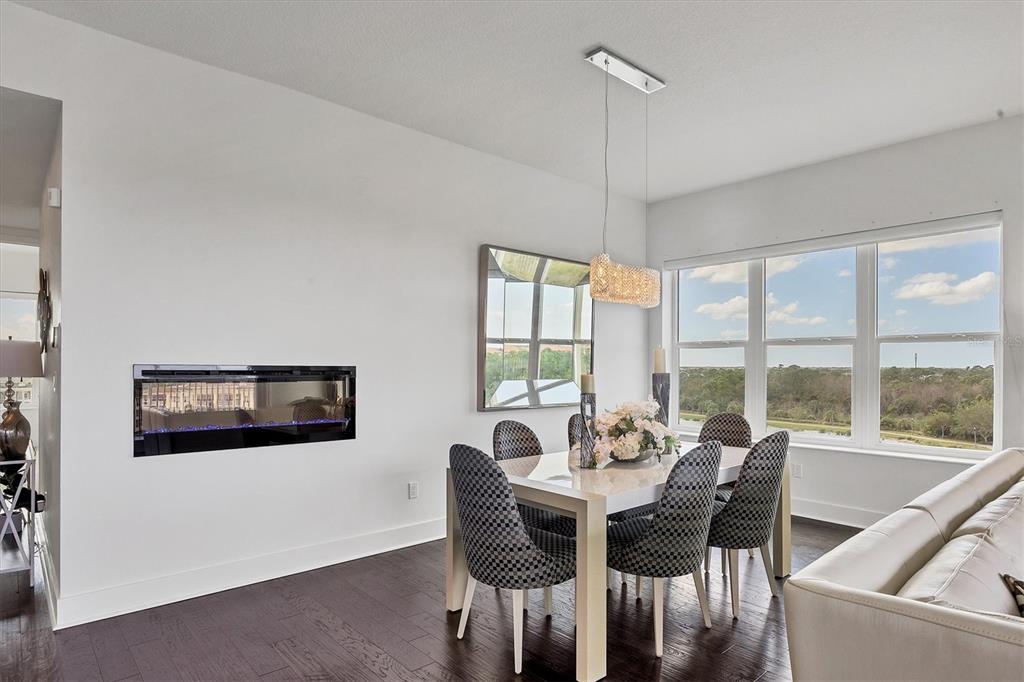 10530 Boardwalk Loop, Unit 601 Bradenton, FL 34202 - Photo 17 of 60 a dining room with furniture a chandelier and wooden floor