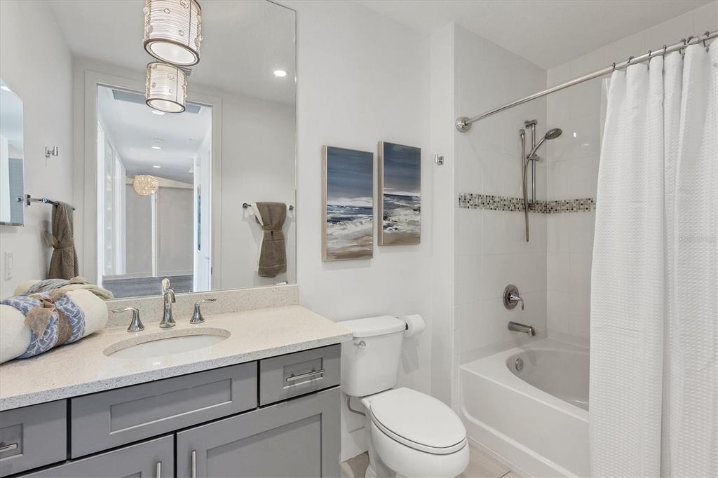 10530 Boardwalk Loop, Unit 601 Bradenton, FL 34202 - Photo 25 of 60 a bathroom with a granite countertop sink a toilet and shower