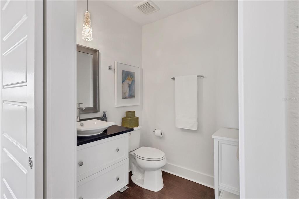 10530 Boardwalk Loop, Unit 601 Bradenton, FL 34202 - Photo 27 of 60 a bathroom with a toilet a sink and a mirror