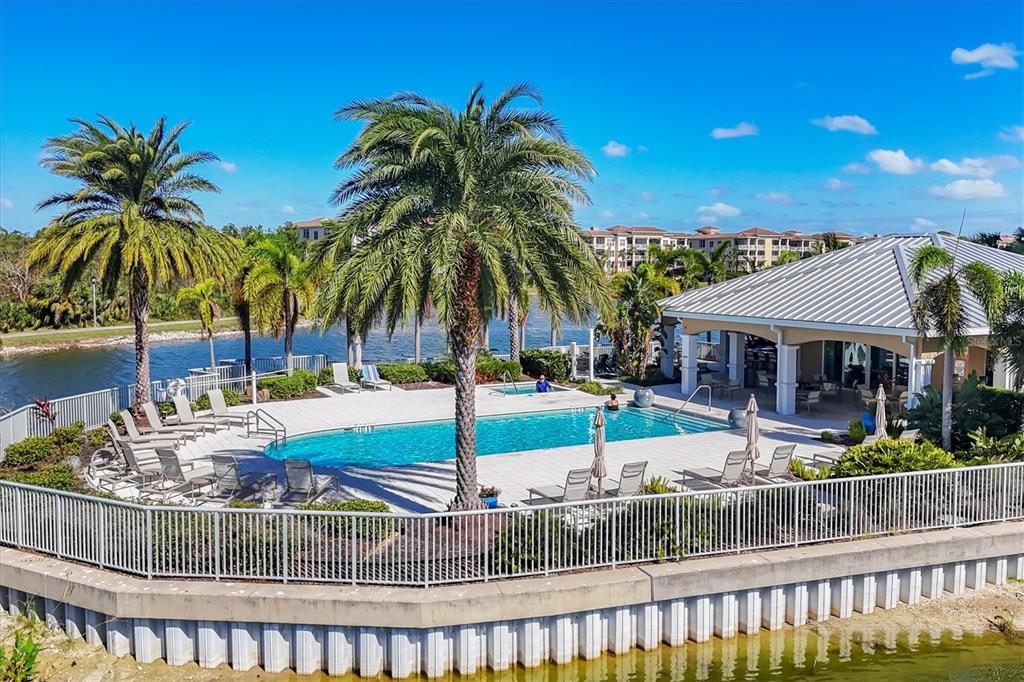 10530 Boardwalk Loop, Unit 601 Bradenton, FL 34202 - Photo 47 of 60 a palm tree sitting in front of a house with a yard