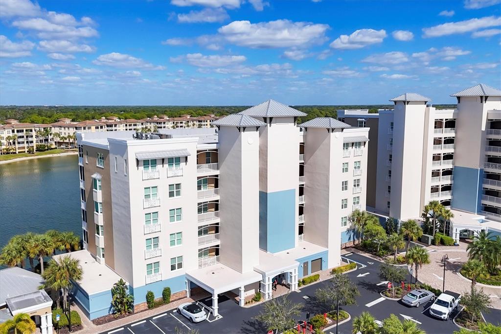 10530 Boardwalk Loop, Unit 601 Bradenton, FL 34202 - Photo 52 of 60 a front view of a building with glass windows and plants