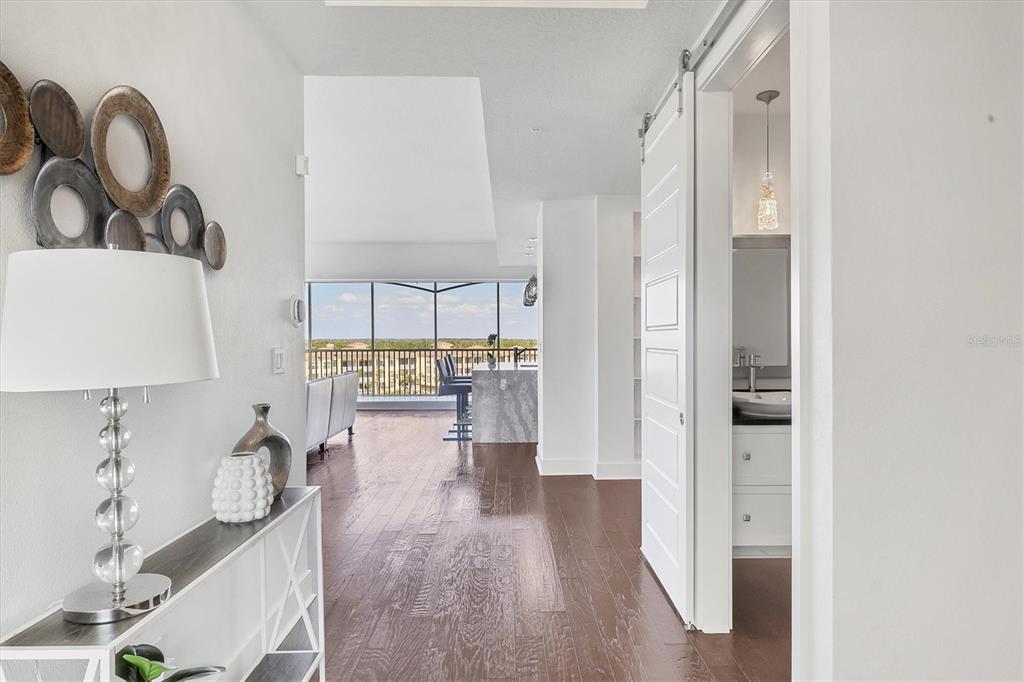 10530 Boardwalk Loop, Unit 601 Bradenton, FL 34202 - Photo 6 of 60 a hallway with white cabinets and wooden floor