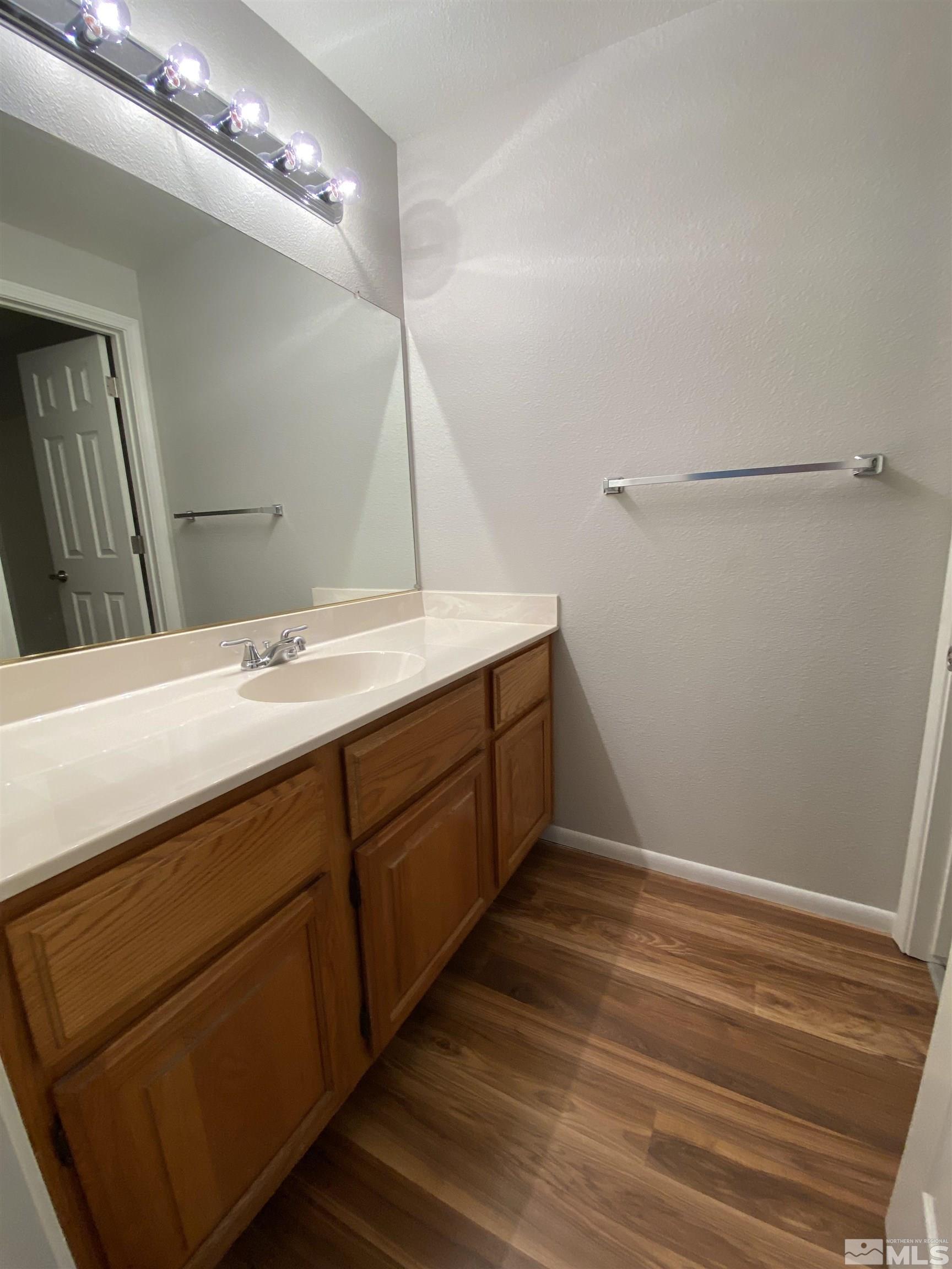 1562 Bramble Court Reno, NV 89509 - Photo 19 of 22 a bathroom with a sink and a mirror