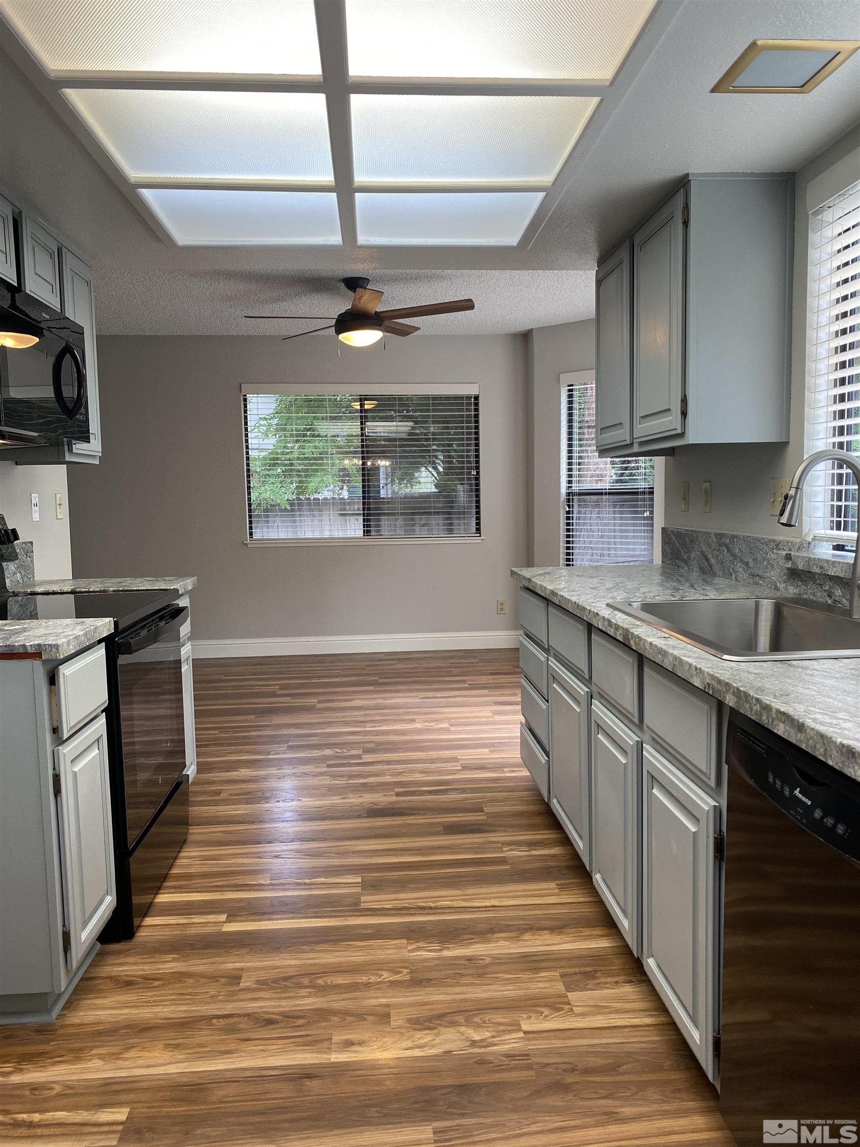 1562 Bramble Court Reno, NV 89509 - Photo 10 of 22 a kitchen with stainless steel appliances granite countertop a sink stove and refrigerator