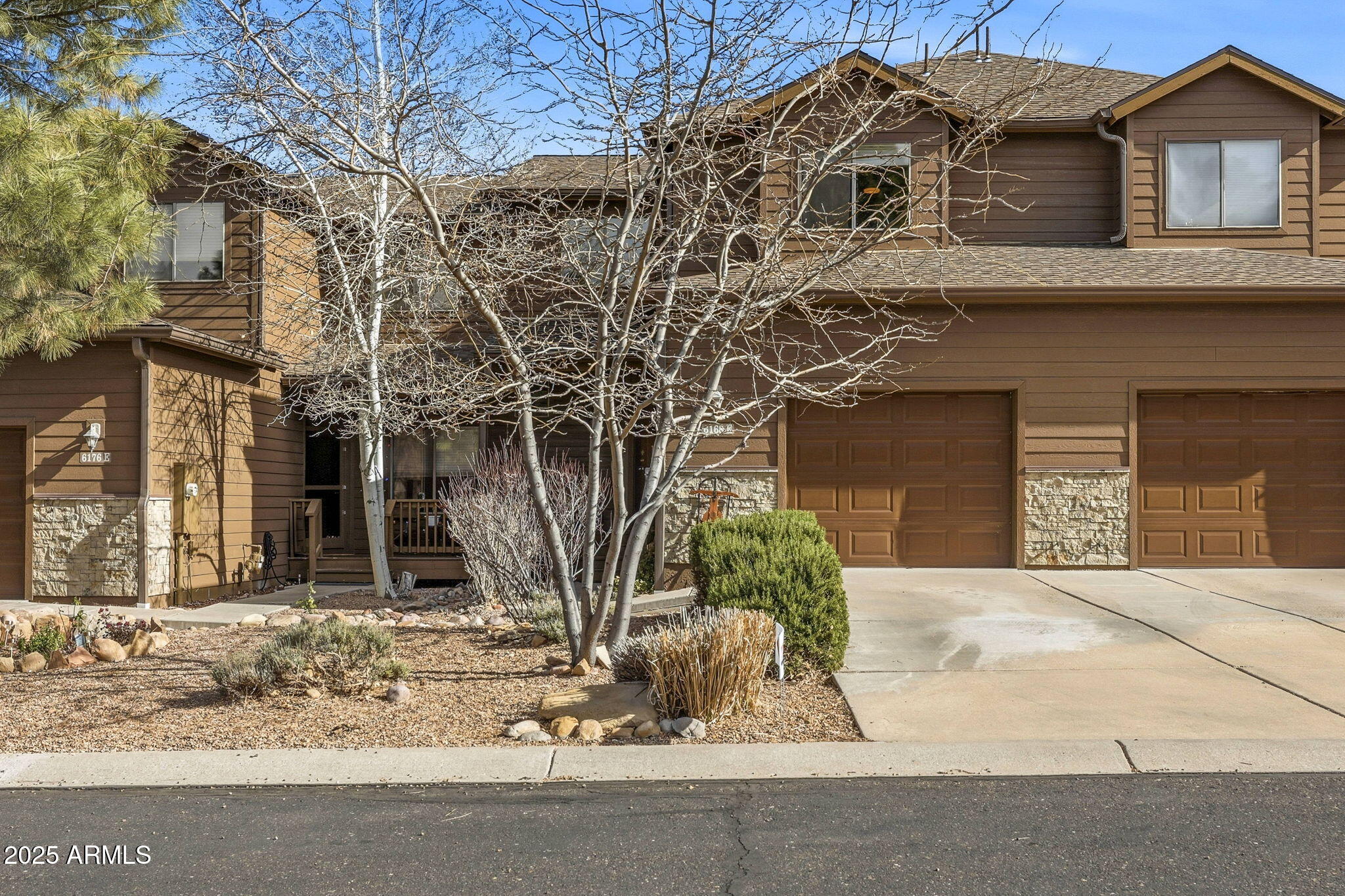 6168 West Starlight Ridge Parkway Lakeside, AZ 85929 - Photo 2 of 39 a front view of a house with a yard and garage