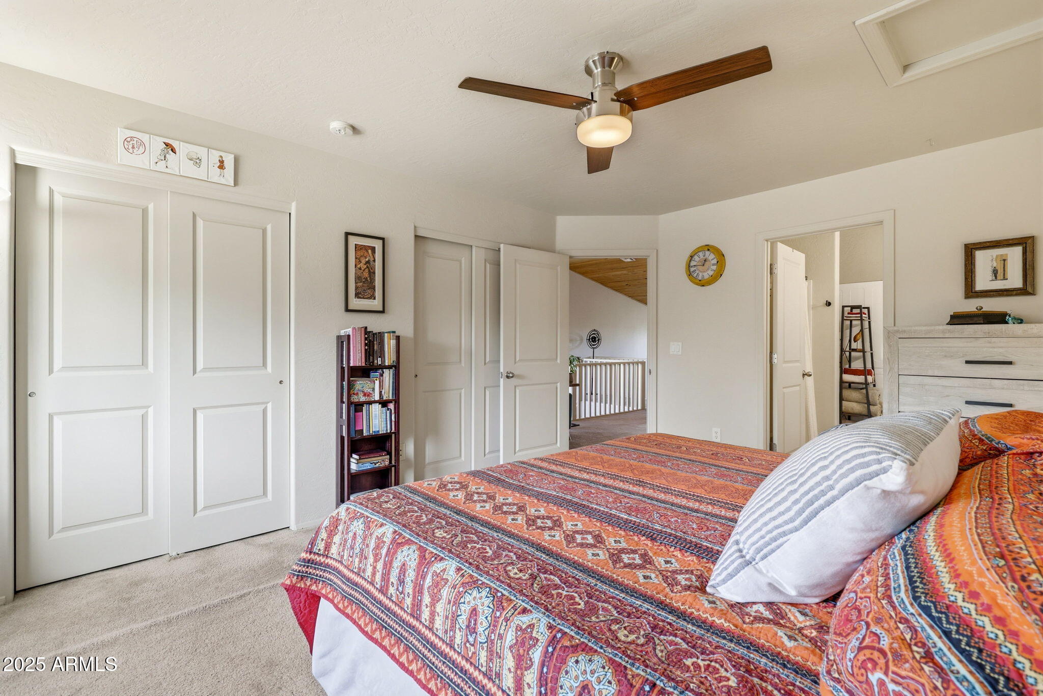 6168 West Starlight Ridge Parkway Lakeside, AZ 85929 - Photo 21 of 42 a bedroom with a bed a dresser and book shelf