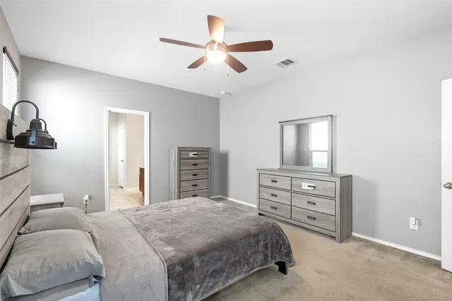 a bedroom with a bed a lamp and a large closet