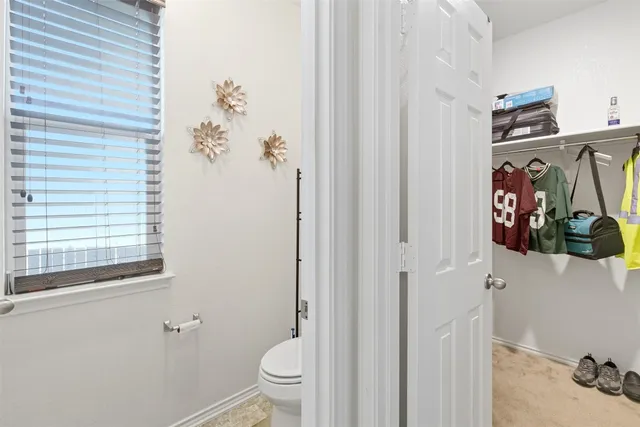 a bathroom with a toilet sink and shower curtain