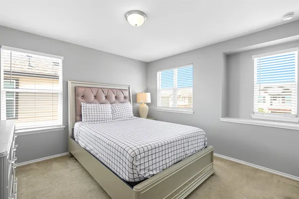 a bedroom with a bed and a window