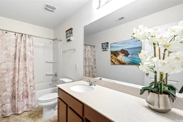 a bathroom with a sink a toilet and a shower