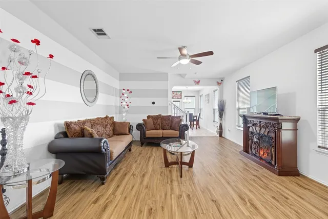 a living room with furniture and a wooden floor