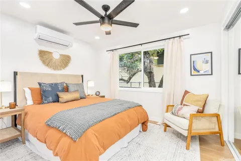 a bedroom with a bed and wooden floor