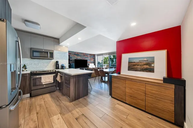 a kitchen with a refrigerator and a stove top oven