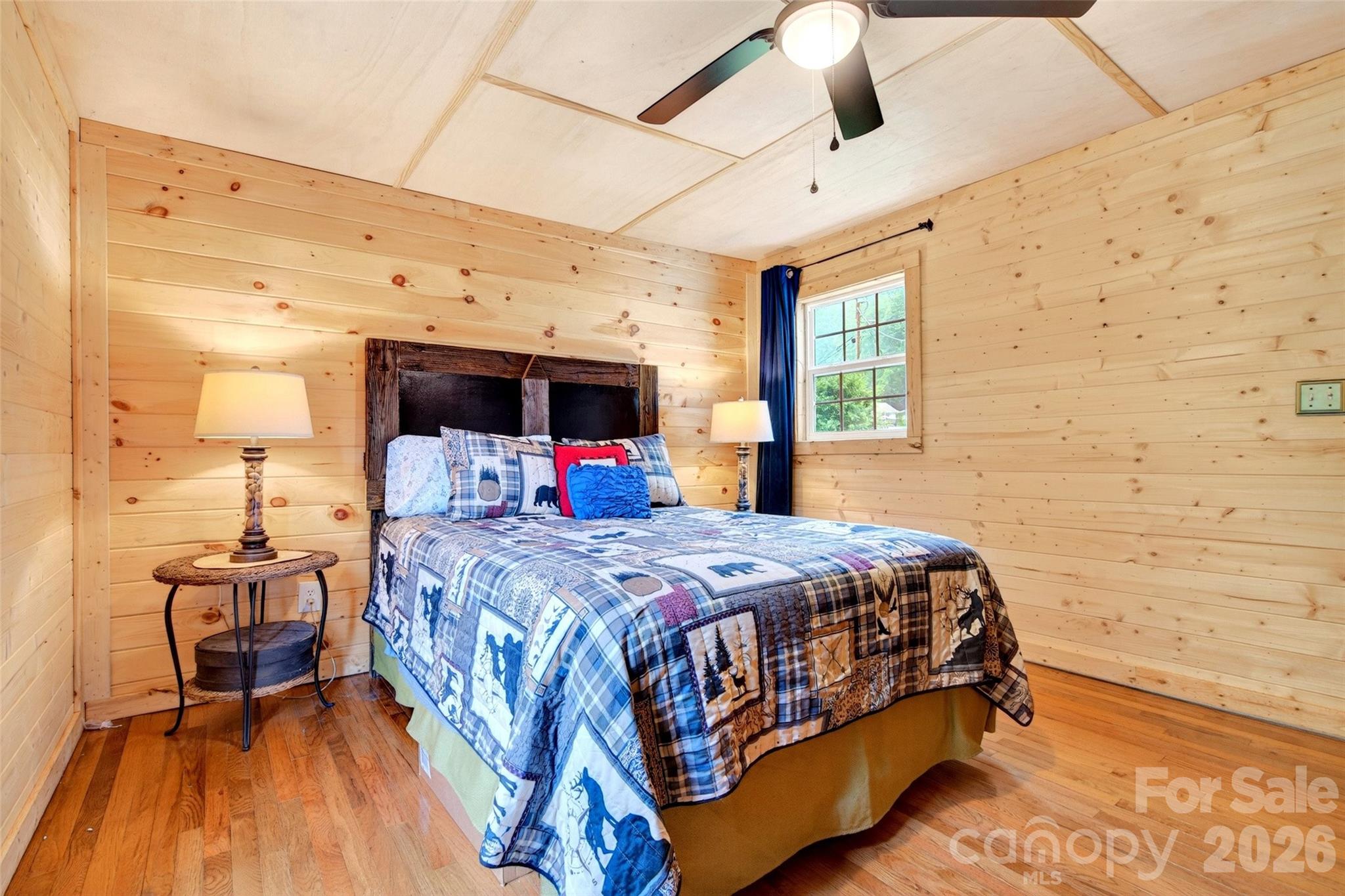 227 Locust Cove Road Marion, NC 28752 - Photo 10 of 34 a bedroom with a bed and wooden floor