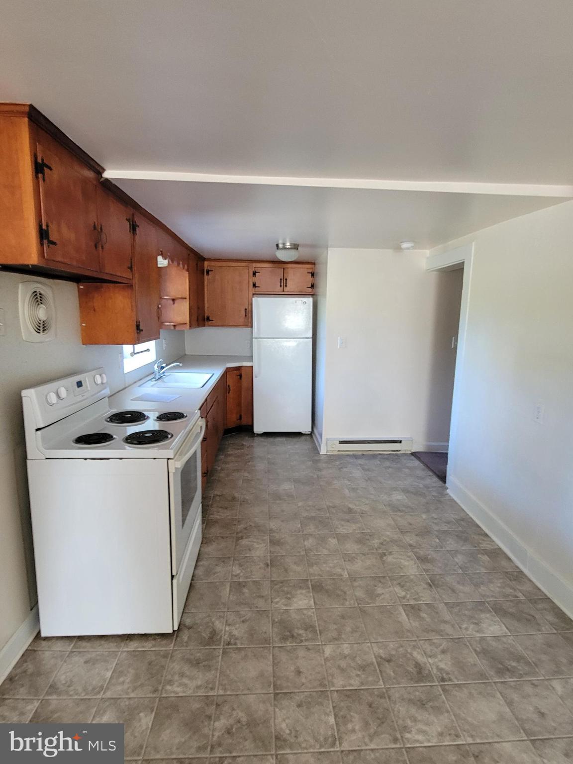 2095 Hosensack Road, Unit B Palm, PA 18070 - Photo 6 of 13 a kitchen with a stove a refrigerator and cabinets