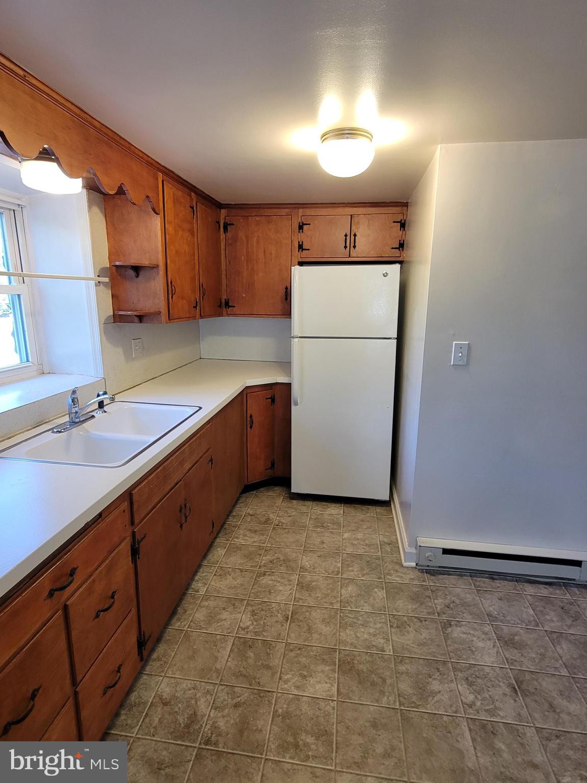 2095 Hosensack Road, Unit B Palm, PA 18070 - Photo 7 of 13 a kitchen with sink a refrigerator and a cabinets