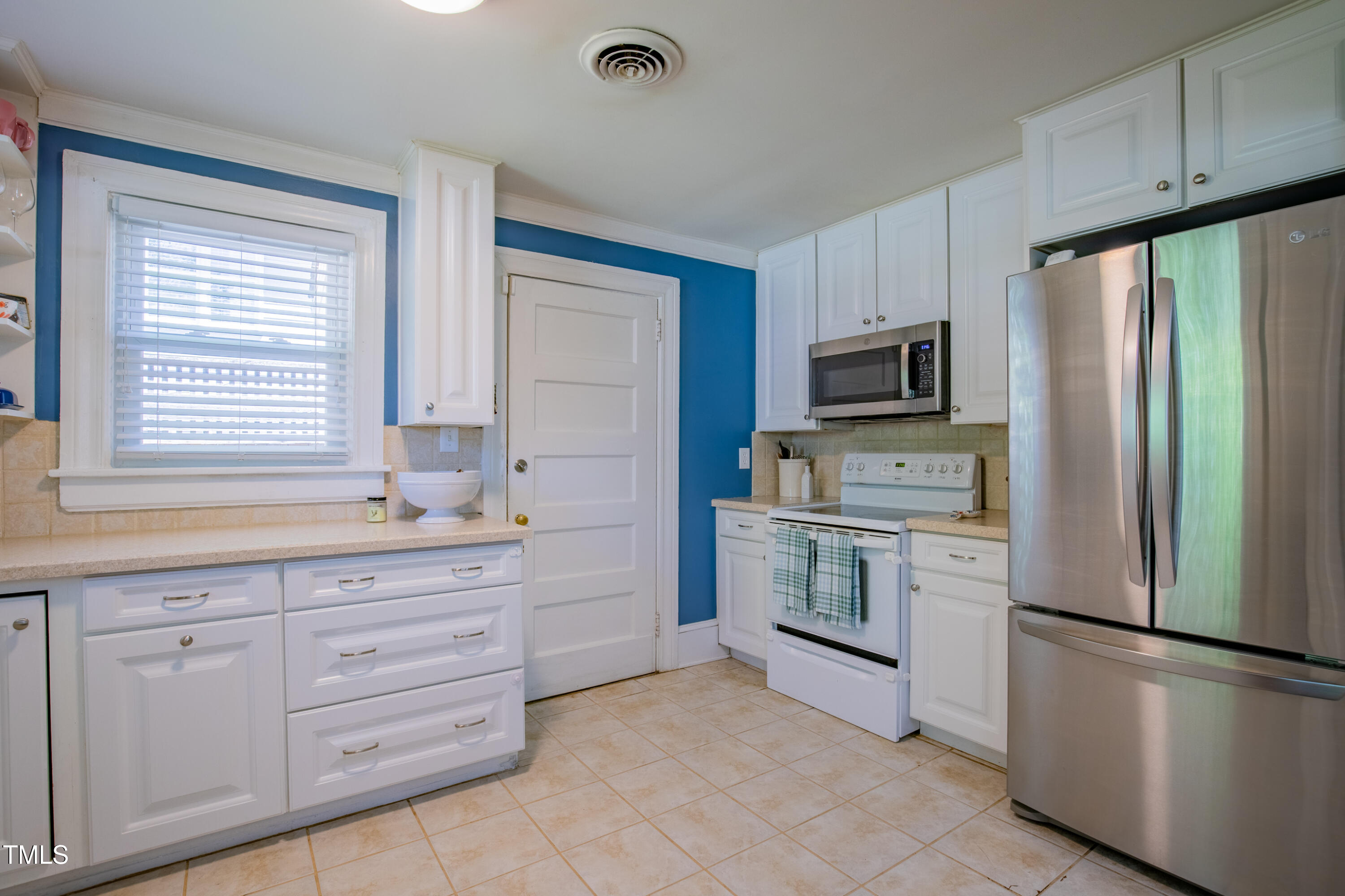 1714 Carson Street Raleigh, NC 27608 - Photo 17 of 38 a kitchen with granite countertop cabinets stainless steel appliances and a window