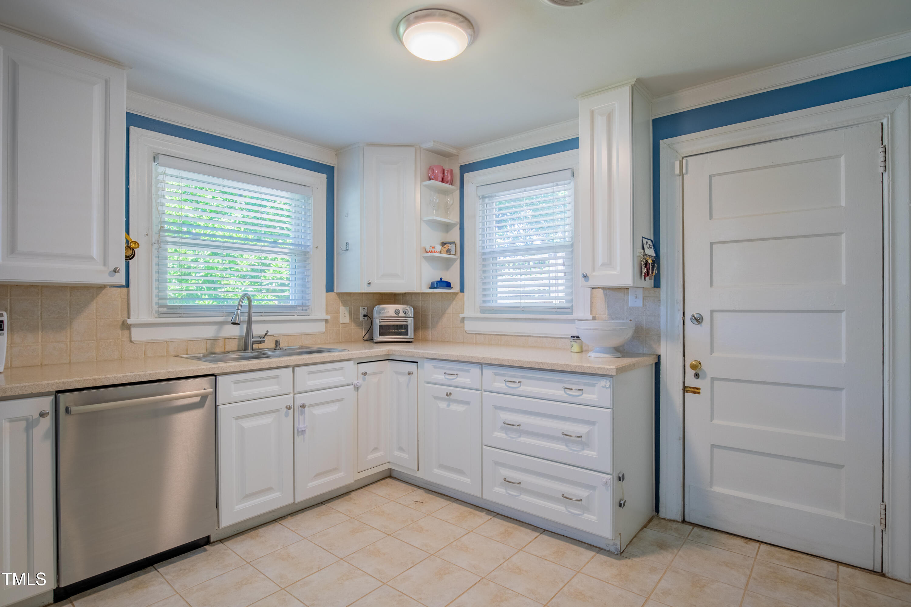 1714 Carson Street Raleigh, NC 27608 - Photo 18 of 38 a kitchen with sink cabinets and window