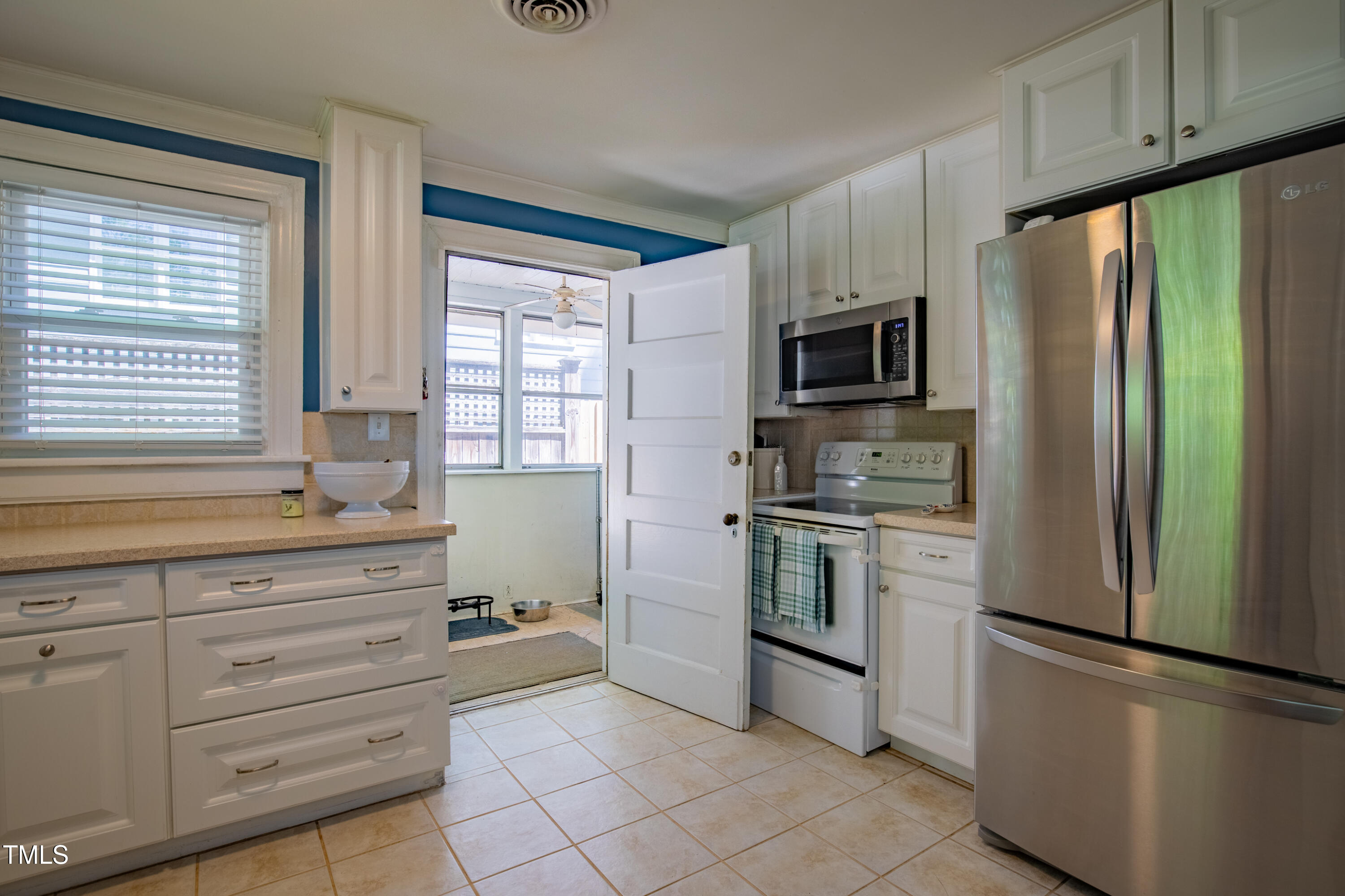 1714 Carson Street Raleigh, NC 27608 - Photo 19 of 38 a kitchen with granite countertop cabinets appliances and a window