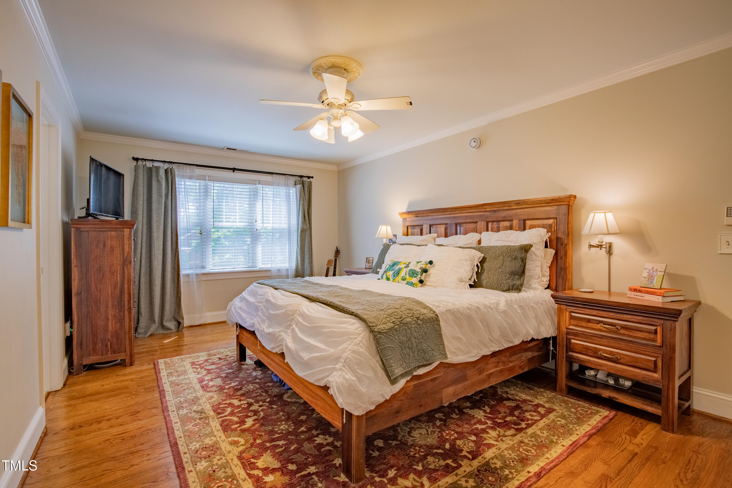 1714 Carson Street Raleigh, NC 27608 - Photo 21 of 38 a bedroom with a bed and wooden floor