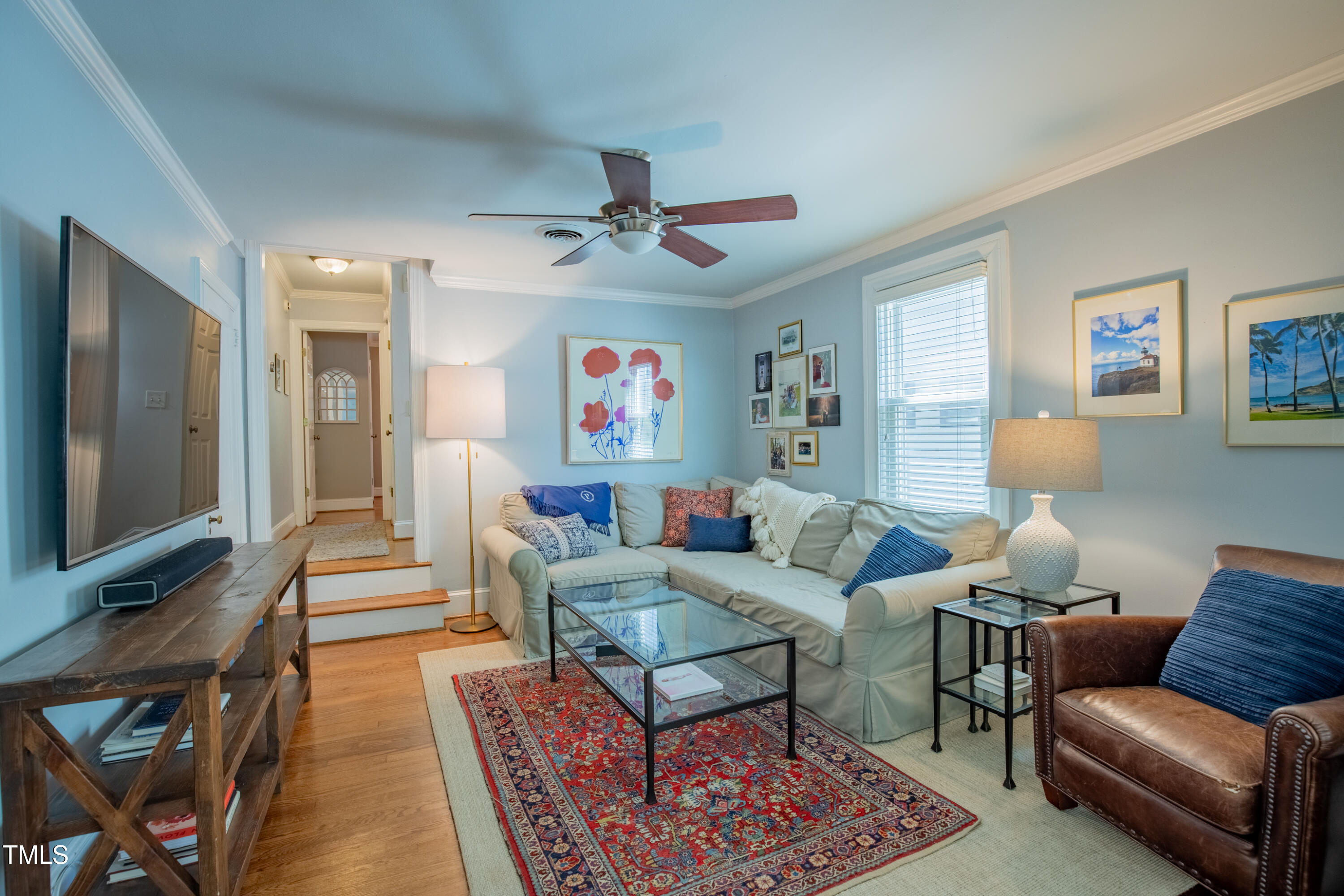 1714 Carson Street Raleigh, NC 27608 - Photo 10 of 38 a living room with furniture a flat screen tv and a rug