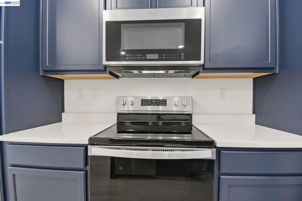 a stove top oven sitting inside of a kitchen