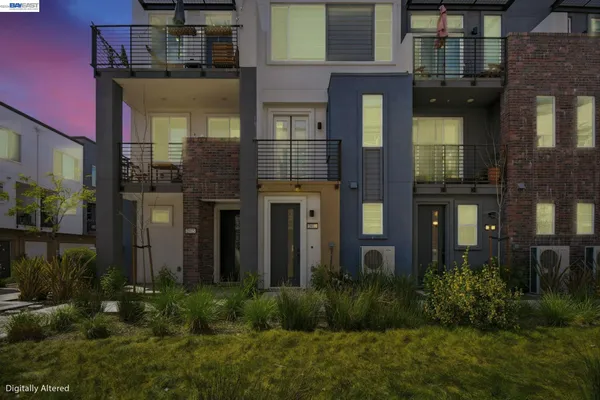 a front view of a residential apartment building with a yard