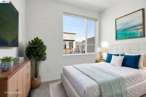 a bedroom with a bed and a potted plant