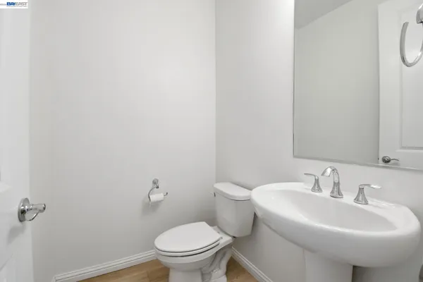 a white toilet sitting next to a white sink