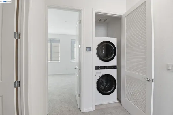 a view of a hallway with washer and dryer