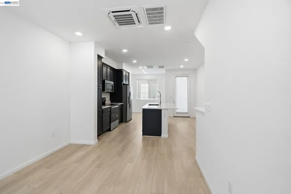 a view of a kitchen with wooden floor
