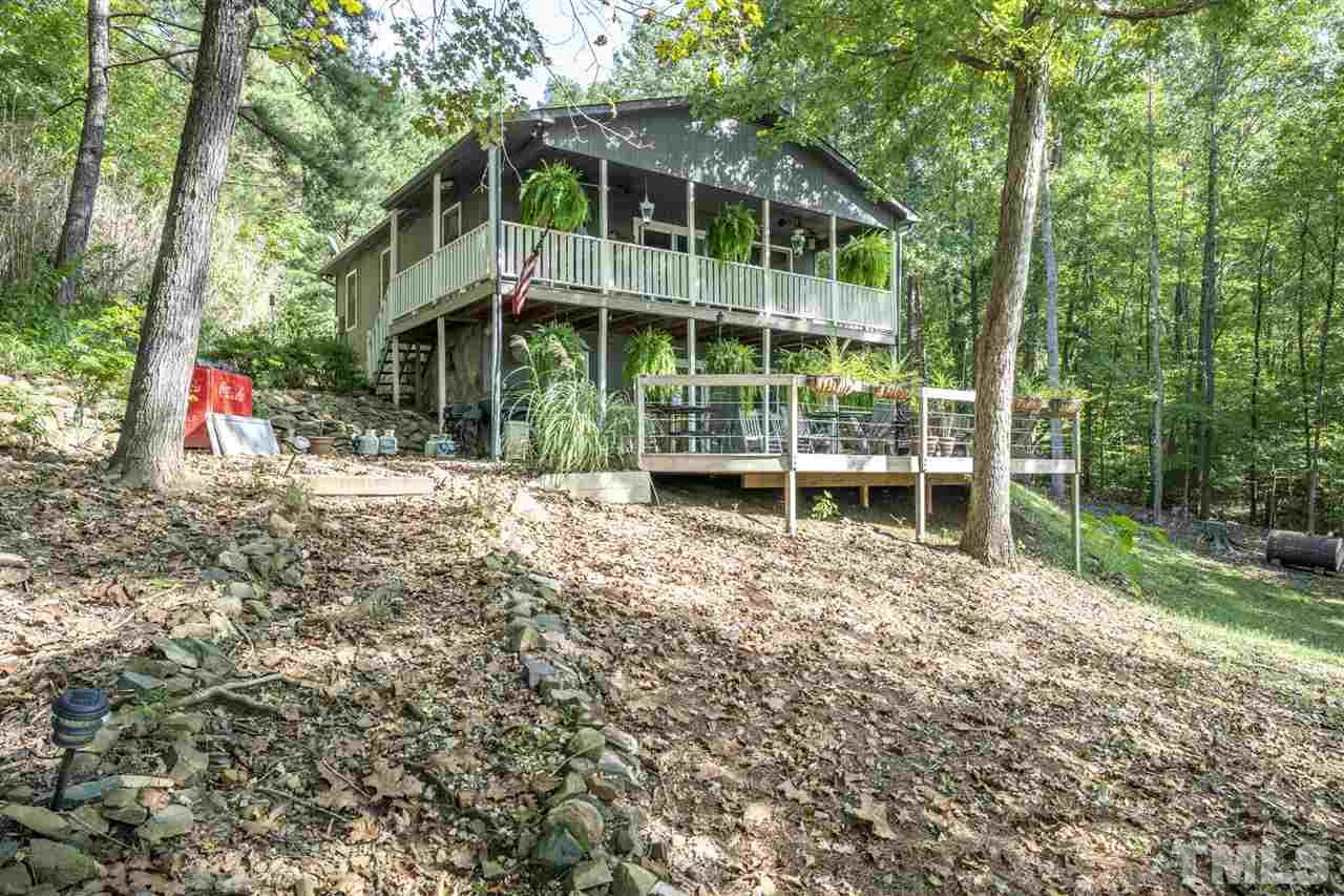 167 Hidden Hills Road Roxboro, NC 27574 - Photo 11 of 25 a view of a house with backyard and sitting area